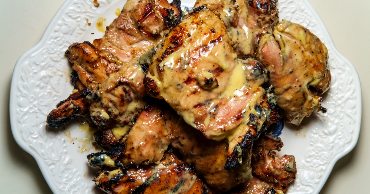 Create an image featuring a woman serving a dish of [alice springs chicken recipe