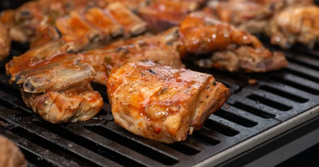 Grilled boneless chicken thighs seasoned and cooked to perfection on a barbecue grill.